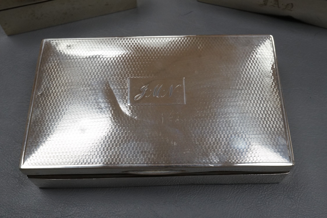 Three assorted silver mounted cigarette boxes, the largest by Frederick William Hentsch, London, 1924, 14.3cm.